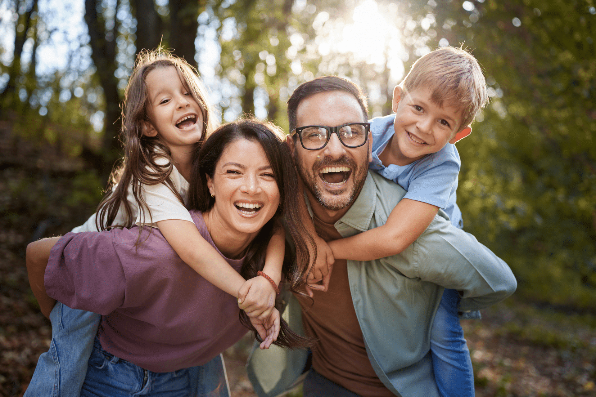 Family smiling together while considering one dentist in Winchester, VA