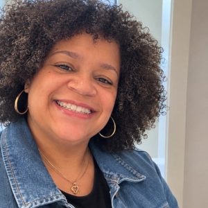 Tabitha Breeden, Office Manager at Westover Family Dentistry in Winchester, VA, smiling in a denim jacket